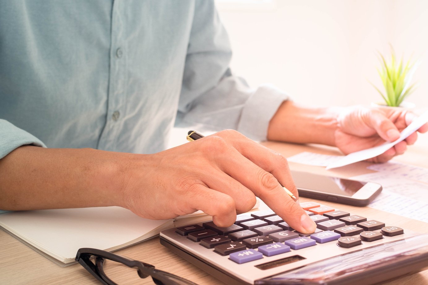 Person Calculating Bills